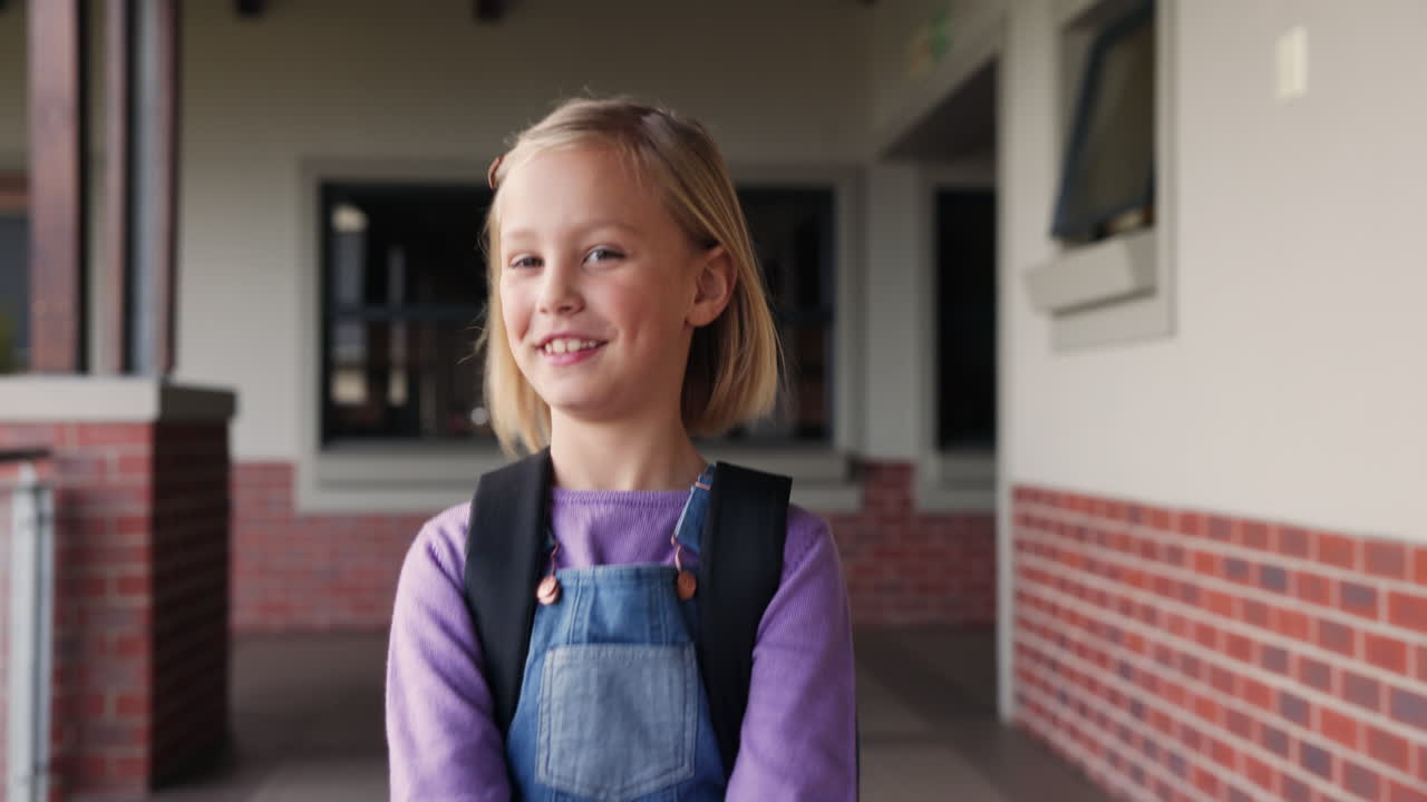 Girl with a backpack in a school hallway