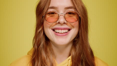 loving female person smiling indoors. romantic girl staring at lens in studio