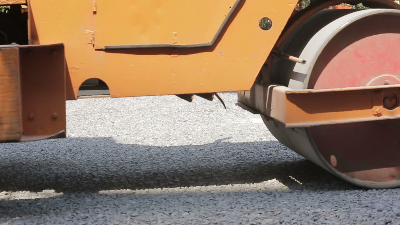 Road construction works with steamroller machine