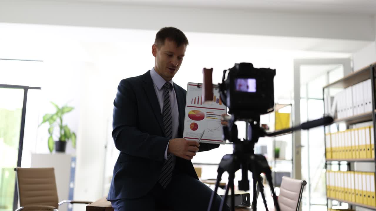 Businessman Recording an Online Business Presentation with Charts