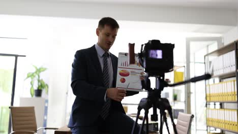 businessman recording an online business presentation with charts