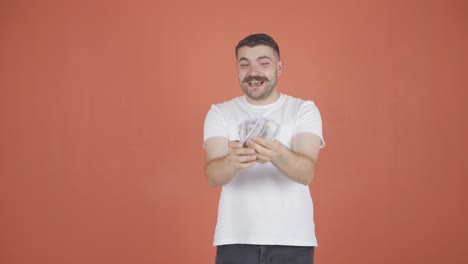 man counting money looking at camera.