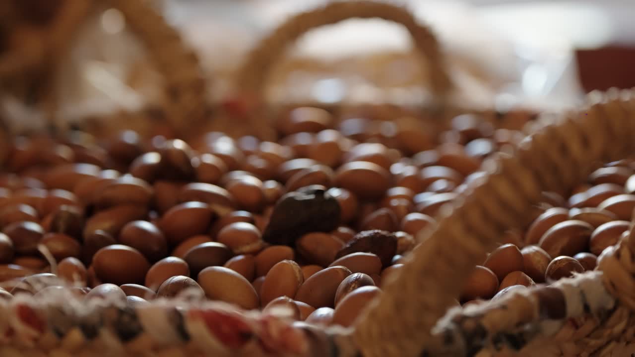A woven basket filled with argan nuts on display at a traditional Moroccan market