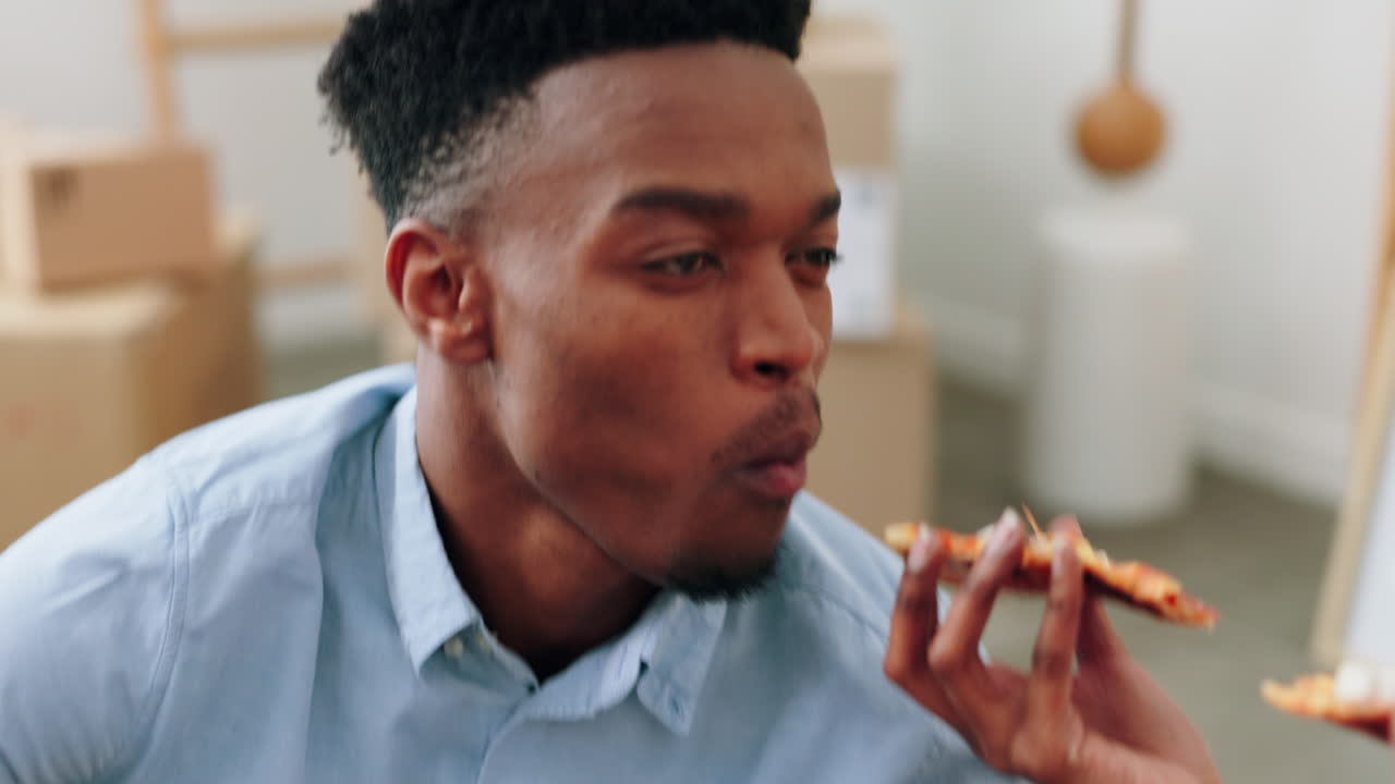 Homeowner couple eating pizza in new house