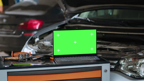 green screen laptop in auto repair shop