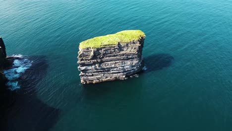 drone shot looking down on downpatrick head and flying right to left