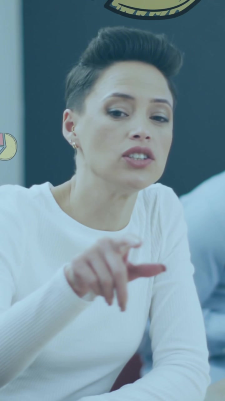 Animation of pie graph icons against caucasian woman discussing with her colleagues at office