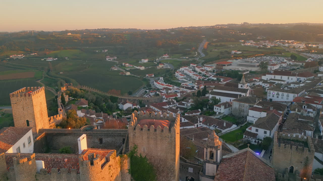 Drone ancient fortress picturesque Portugal village illuminated by sunset light.
