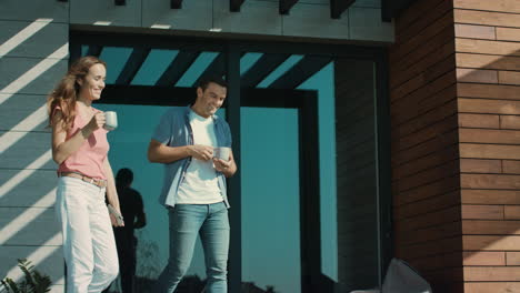 Beautiful-couple-drinking-coffee-on-terrace.-Man-and-woman-talking-outside.