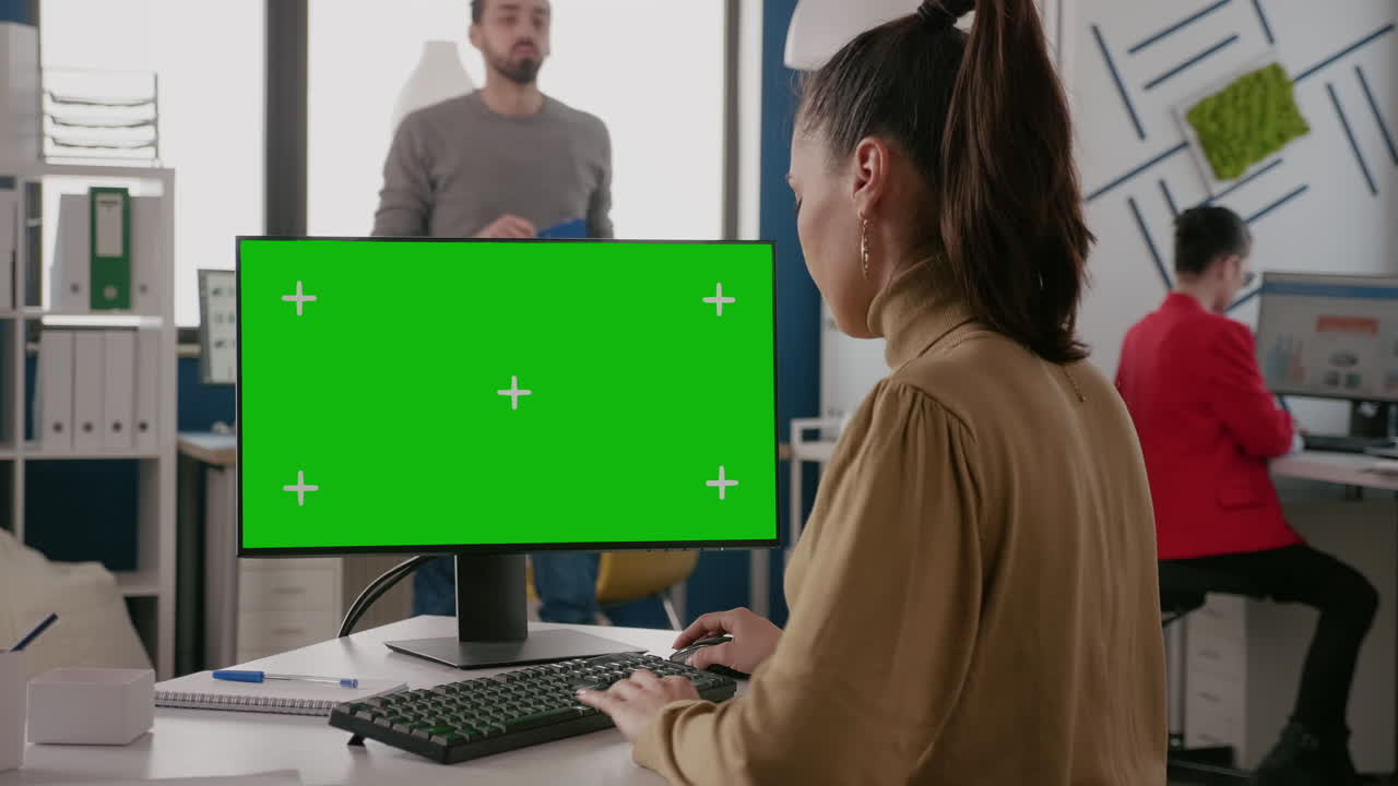 Business woman using monitor with green screen