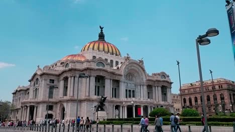 tourists walking through the touristic palace of fine arts (palacio de bellas artes). historic artistic site. mexico.