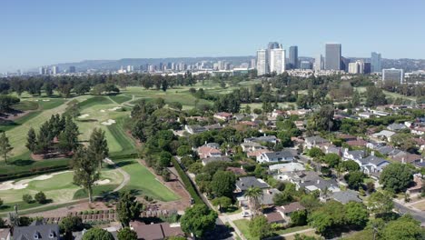 drone shot of century city, los angeles ca usa, homes, business buildings, golf country club fields on sunny day