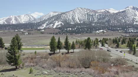 4k drone footage of mammoth lakes in early spring looking out towards the snow-capped eastern sierra