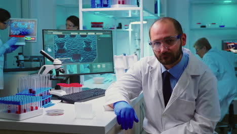 Exhausted-portrait-of-chemist-doctor-looking-up-at-video-camera