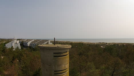 drone shot descends next to world war ii watchtower at bethany beach, delaware