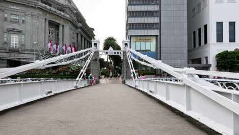 pedestrians crossing a busy city square.