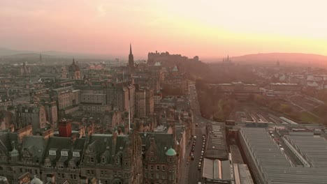 flying a drone towards edinburgh castle at sunset