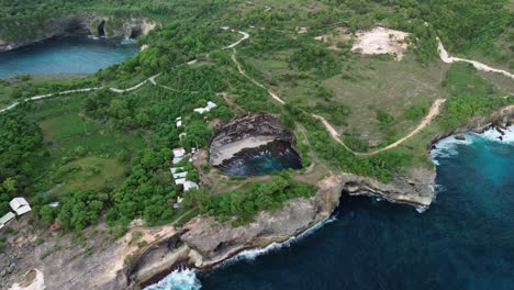 aerial shot of broken beach in nusa penida with waves and rugged cliffs