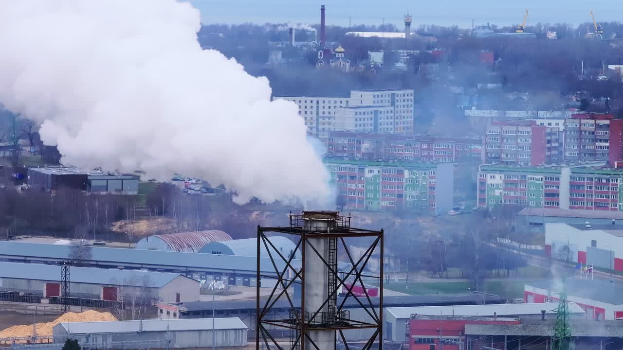 Smoke rising from an industrial chimney over city, environmental issues, spring