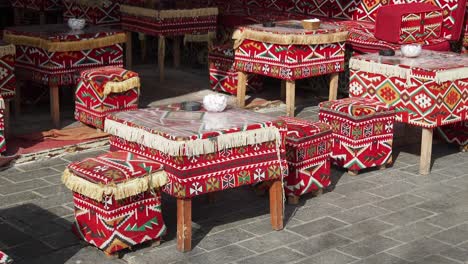 traditional middle eastern street cafe with colorful tables and cushions