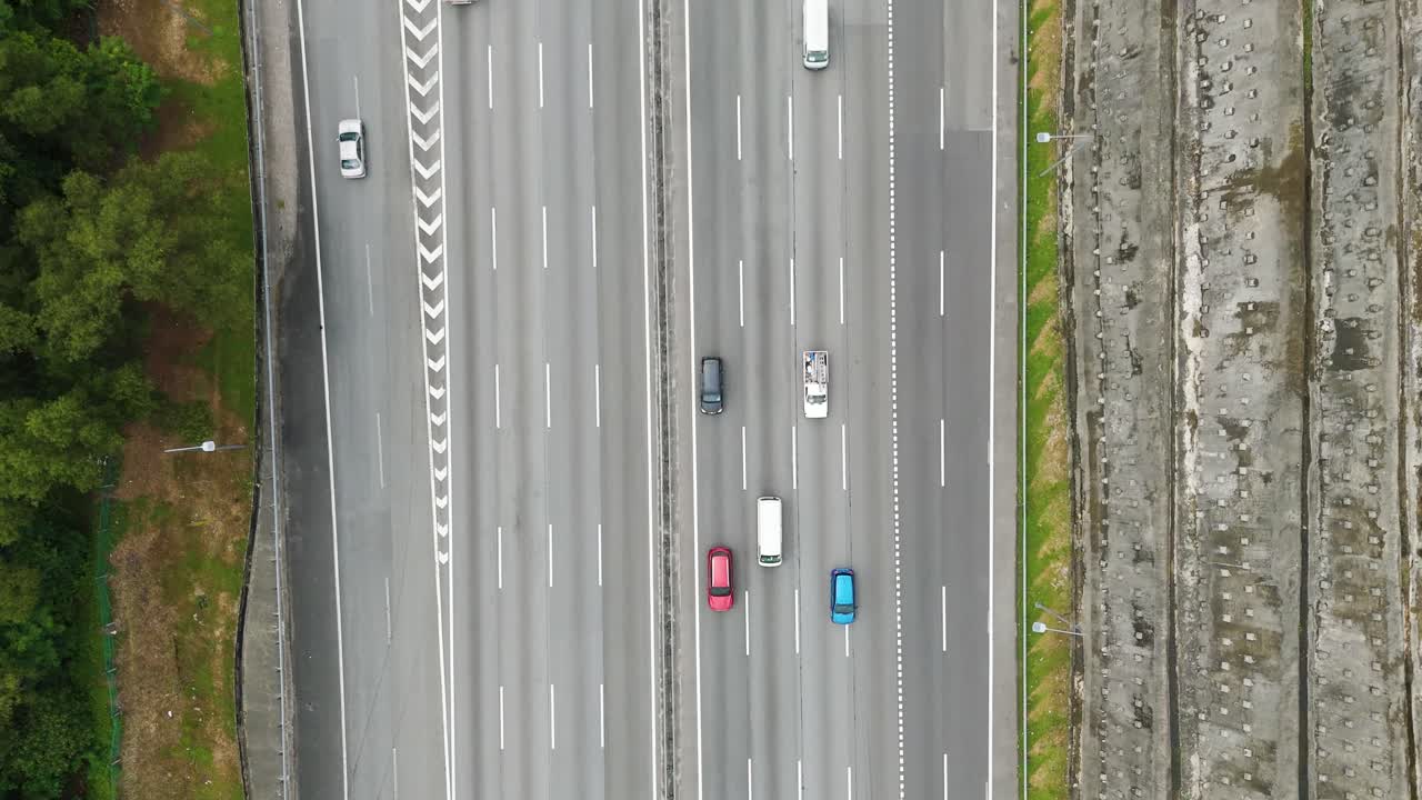 Aerial: highway with cars and traffic during the day in Petaling Jaya, in the state of Selangor, Malaysia, top-down drone shot