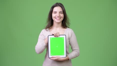 young happy beautiful woman smiling while showing digital tablet