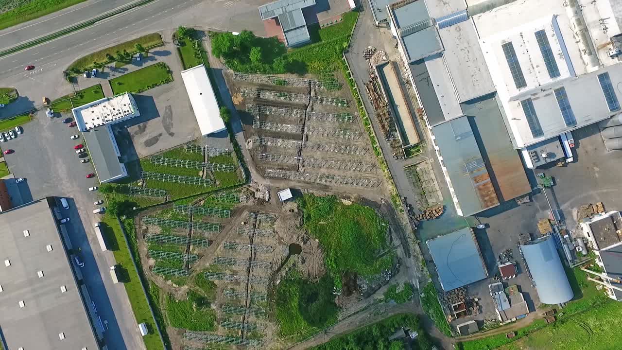 Aerial View of Industrial and Commercial Complex with Construction and Agricultural Elements