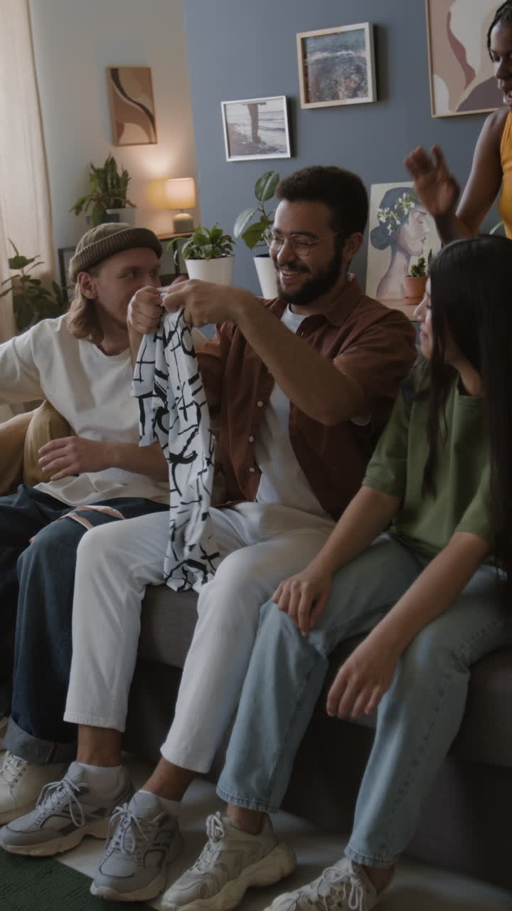 Friends Showing a New Patterned Shirt in the Living Room