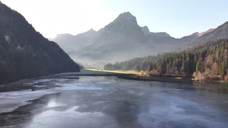 drone flight over lake obersee in the glarus region, switzerland, with the majestic swiss alps in the background.