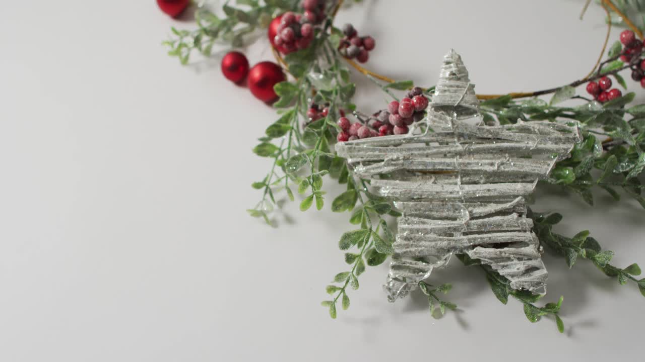 Video of christmas decorations with star and copy space on white background