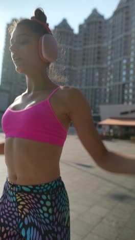 woman exercising outdoors with headphones