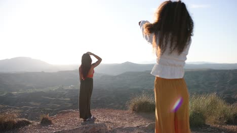 two women enjoying a scenic mountain landscape