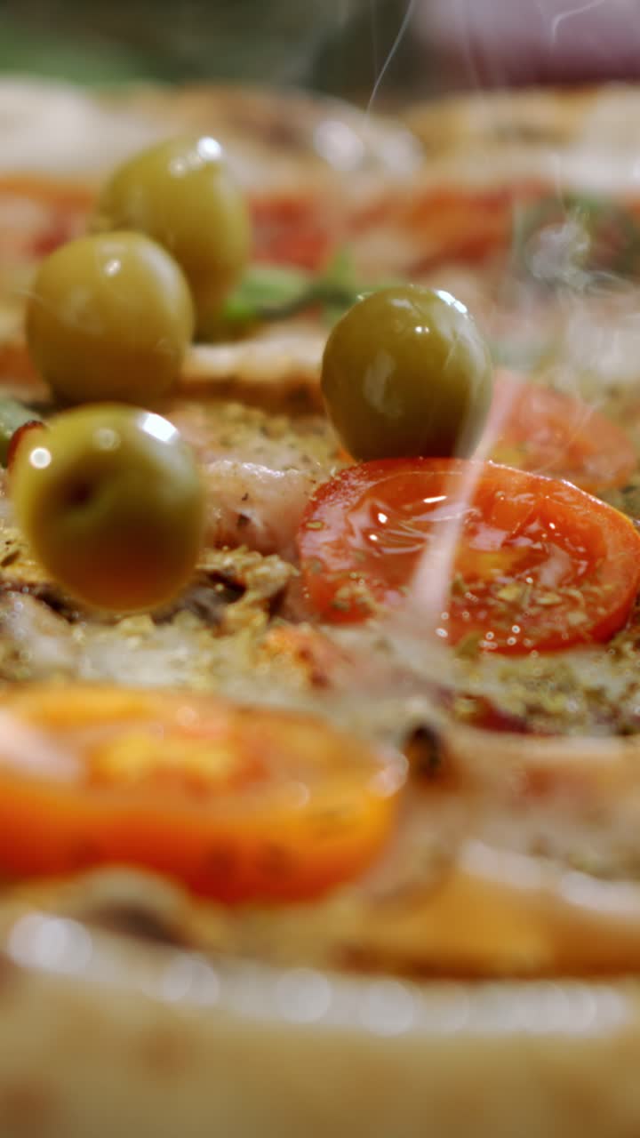 Close-up of a pizza with tomatoes and olives