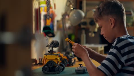 boy building lego robots