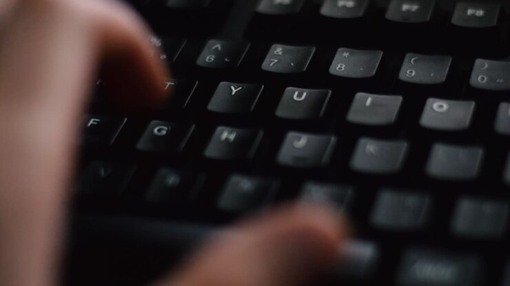 Hand of a man typing on computer keyboard