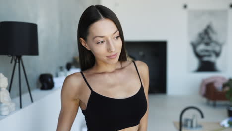woman in black bra posing in a modern apartment