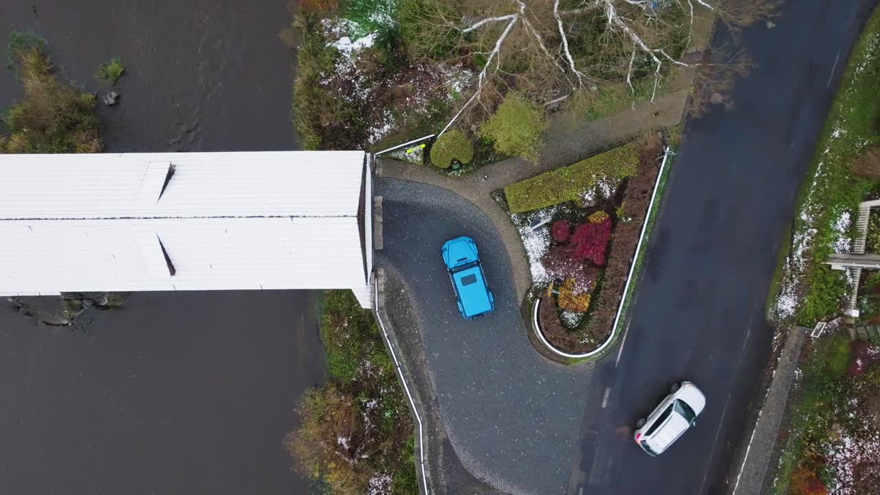 Aerial view of cars at curved road intersection near bridge, Czechia