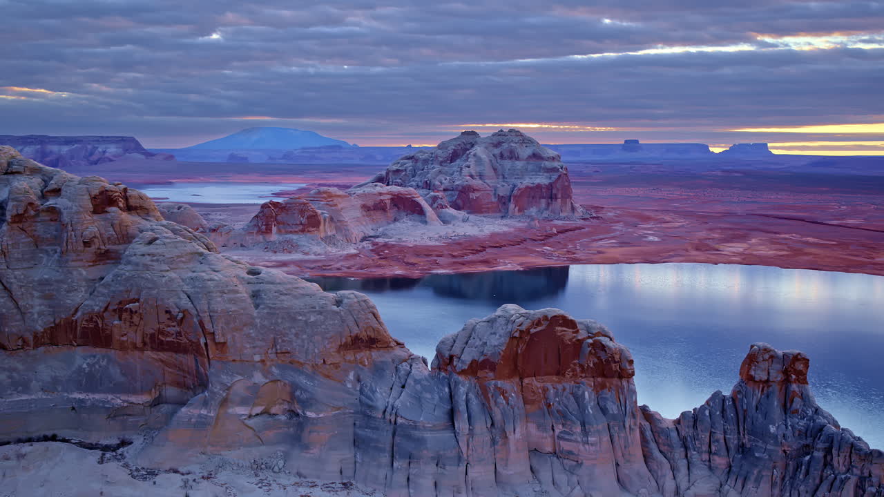 The camera glides across Glen Canyon, focusing on the surreal rock formations sculpted by wind and water.