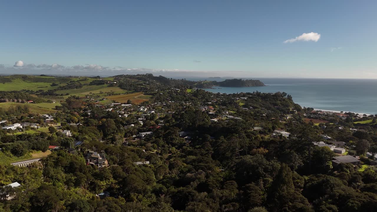 Drone flight over the residential aeria of Onetangi towards the ocean front.