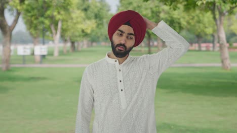 confused sikh indian man thinking in park