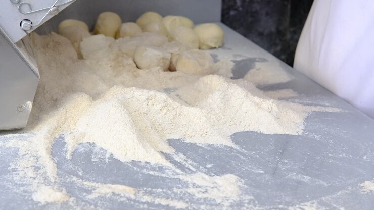 Male chef preparing dough