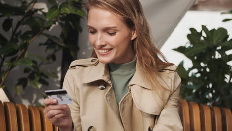 caucasian female student online shopping on laptop outdoors.