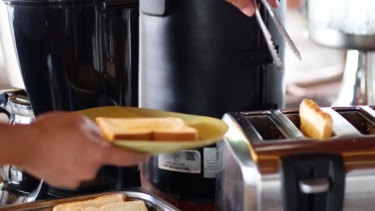 Toasting bread slices with tongs and a toaster