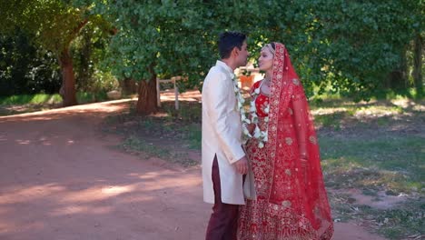 indian wedding couple kissing outdoors - close up