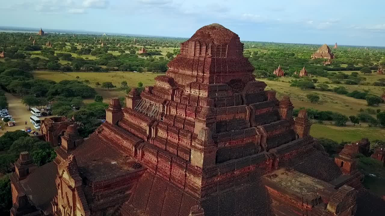 An impressive aerial pull-out shot revealing a vast landscape filled with temple pagodas in Bagan, Myanmar. Perfect for showcasing the expansive beauty and ancient architecture of this historic site.