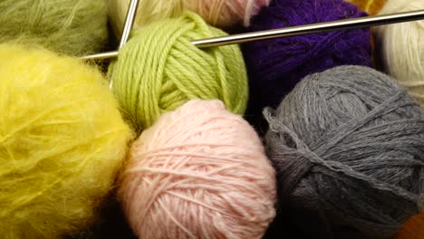 balls of yarn for knitting of  lie on a wooden board