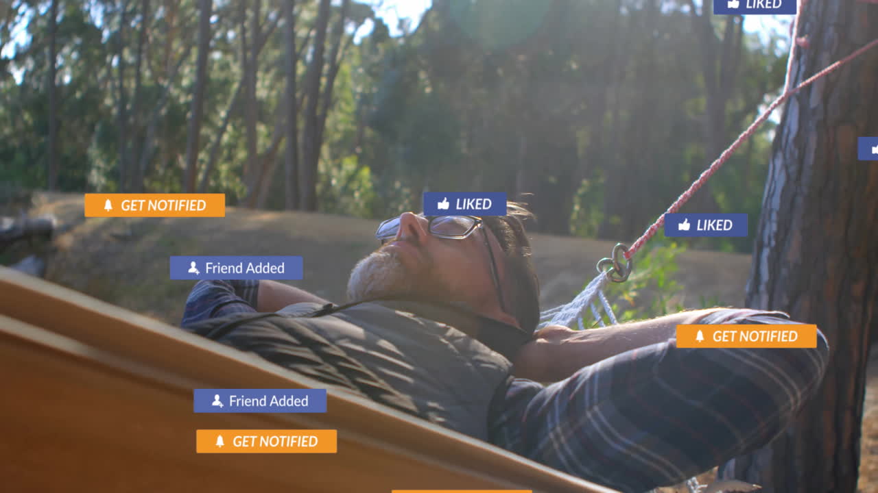 Adult man relaxing in pine forest hammock, viewing social media marketing icons floating overhead