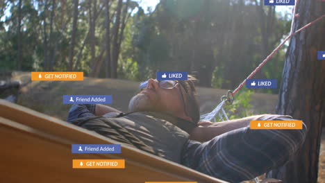 adult man relaxing in pine forest hammock, viewing social media marketing icons floating overhead