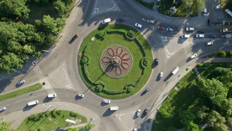4k aerial view of roundabout road with circular cars in small european city at sunny day