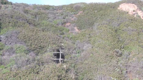 Historic-water-way-flume-drone-shot-raising-up-to-the-ocean-